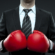 Geschäftsmann mit Boxhandschuhen